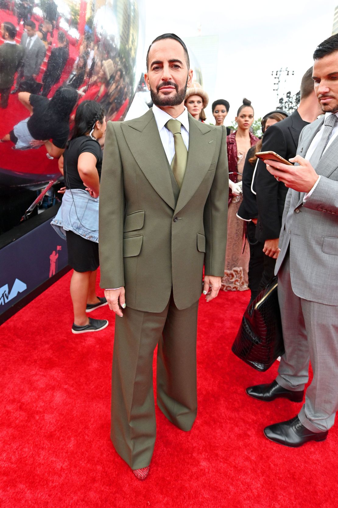 Fashion designer Marc Jacobs paired a wide-leg suit with sequinned red Prada pumps.