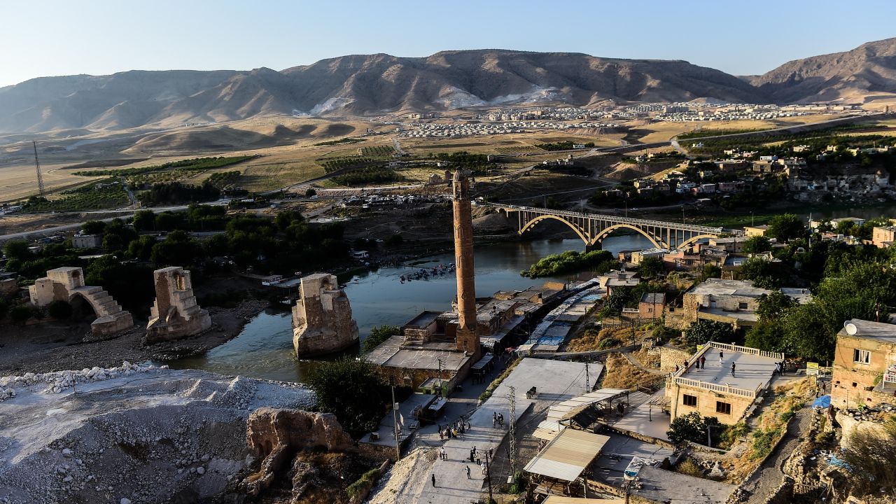 A view of the construction work along the Tigris River that runs through the 12,000-year-old Hasankeyf settlement and ancient citadel town which will soon be significantly submerged by the waters of the nearby Ilisu dam in southeastern Turkey, on July 29, 2018. - The Turkish town of Hasankeyf, a former trading post along the Silk Road, which has seen the Romans, Byzantines, Turkic tribes and Ottomans leave their mark, will soon be partially flooded by the Ilisu Dam, as part of the Southeast Anatolian project (Gap) and one of Turkeys largest hydroelectric projects, which is being built down stream. The inauguration of Turkey's controversial Ilisu dam on the Tigris River will also compound water shortages in neighbouring Iraq. (Photo by Yasin AKGUL / AFP)        (Photo credit should read YASIN AKGUL/AFP/Getty Images)
