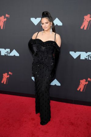 Spanish singer and producer Rosalía, one of the evening's performers, arrived in custom-made Burberry (black satin fringe corset top)