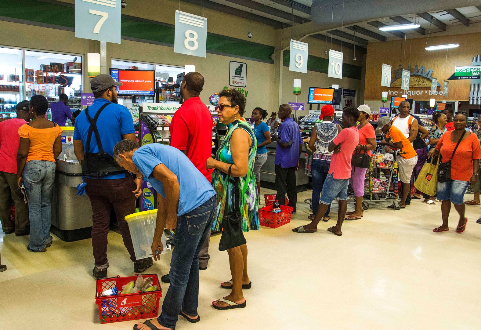 Residents stand in line at a grocery store in Bridgetown on August 26.