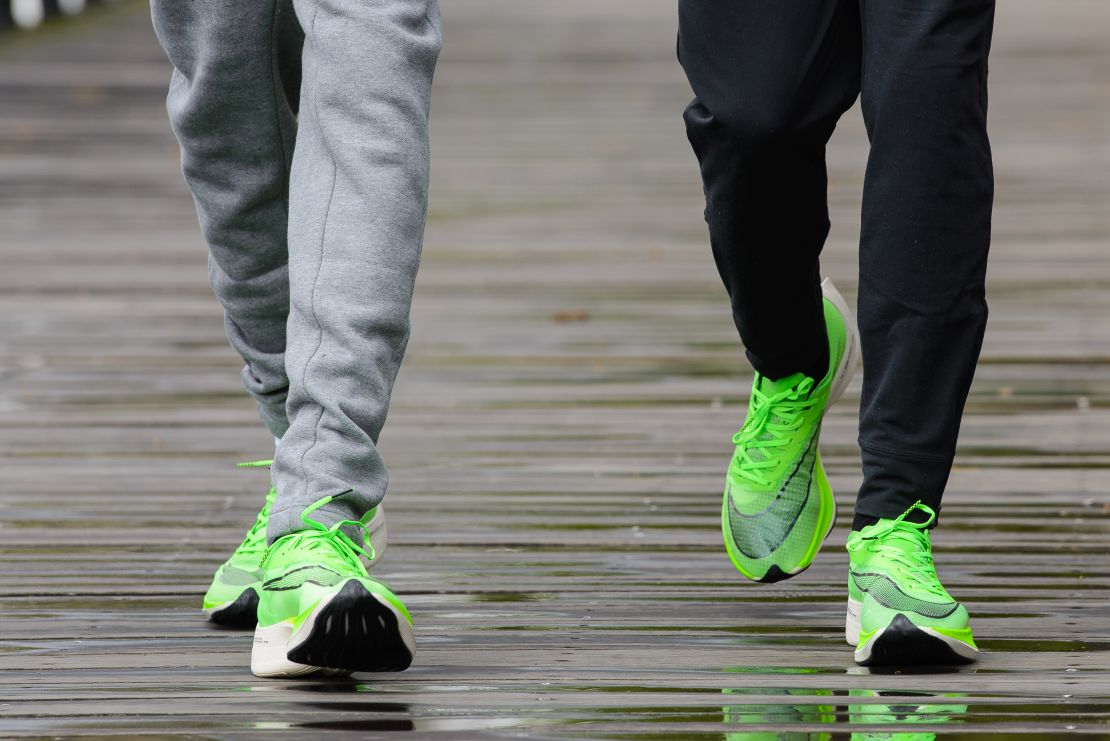 Eliud Kipchoge (right) and Mo Farah (left) show off their running shoes ahead of this year's London marathon. 