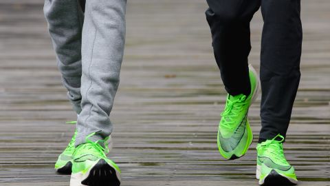 Eliud Kipchoge (right) and Mo Farah (left) show off their running shoes ahead of this year's London marathon. 