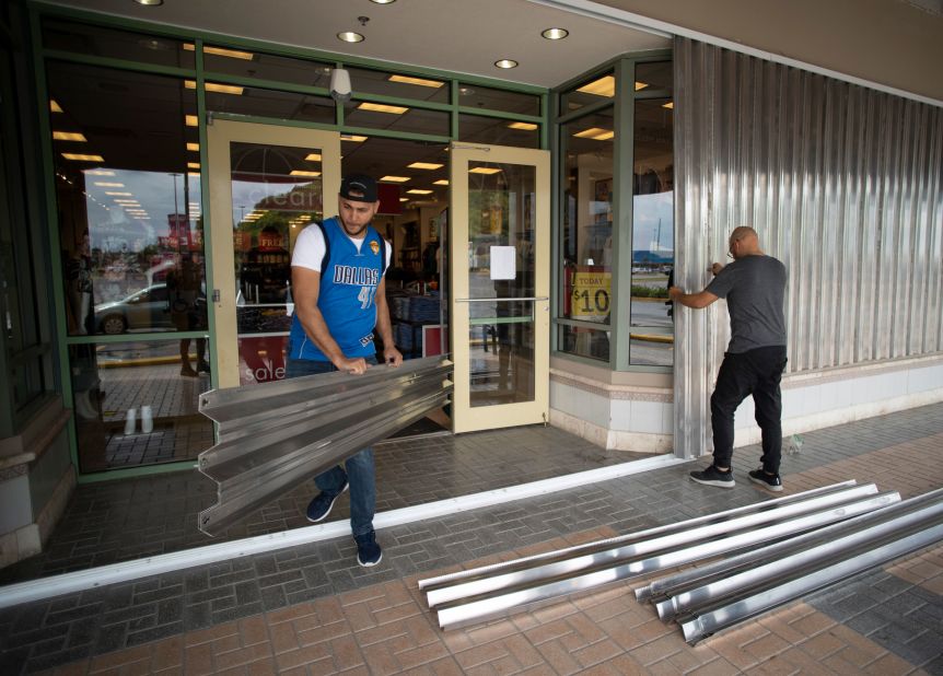 Workers prepare a store's exterior in Humacao, Puerto Rico, on August 28.