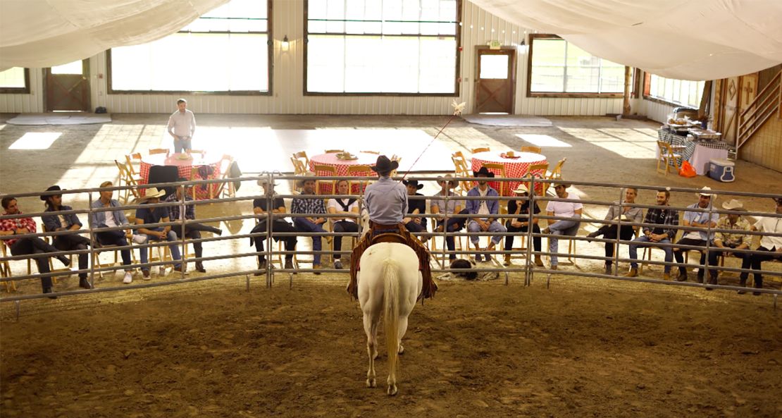 Horse whisperer Grant Golliher leads a demonstration wtih executives.