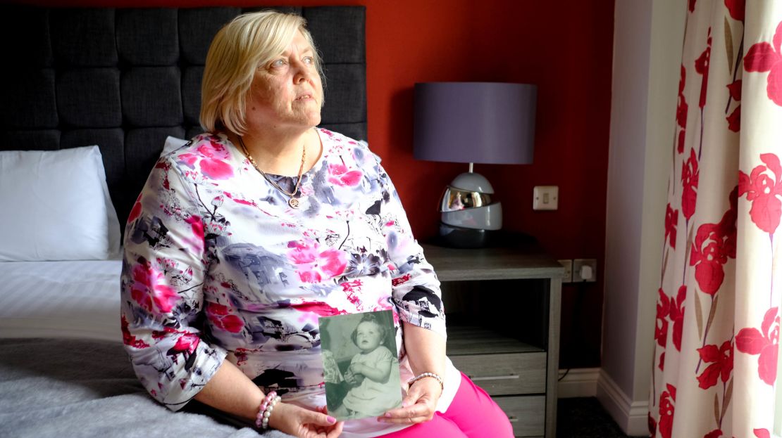 Survivor Teresa O'Sullivan holds a photo of herself as a baby, a photograph that was taken of children who were to be adopted from Tuam home. 