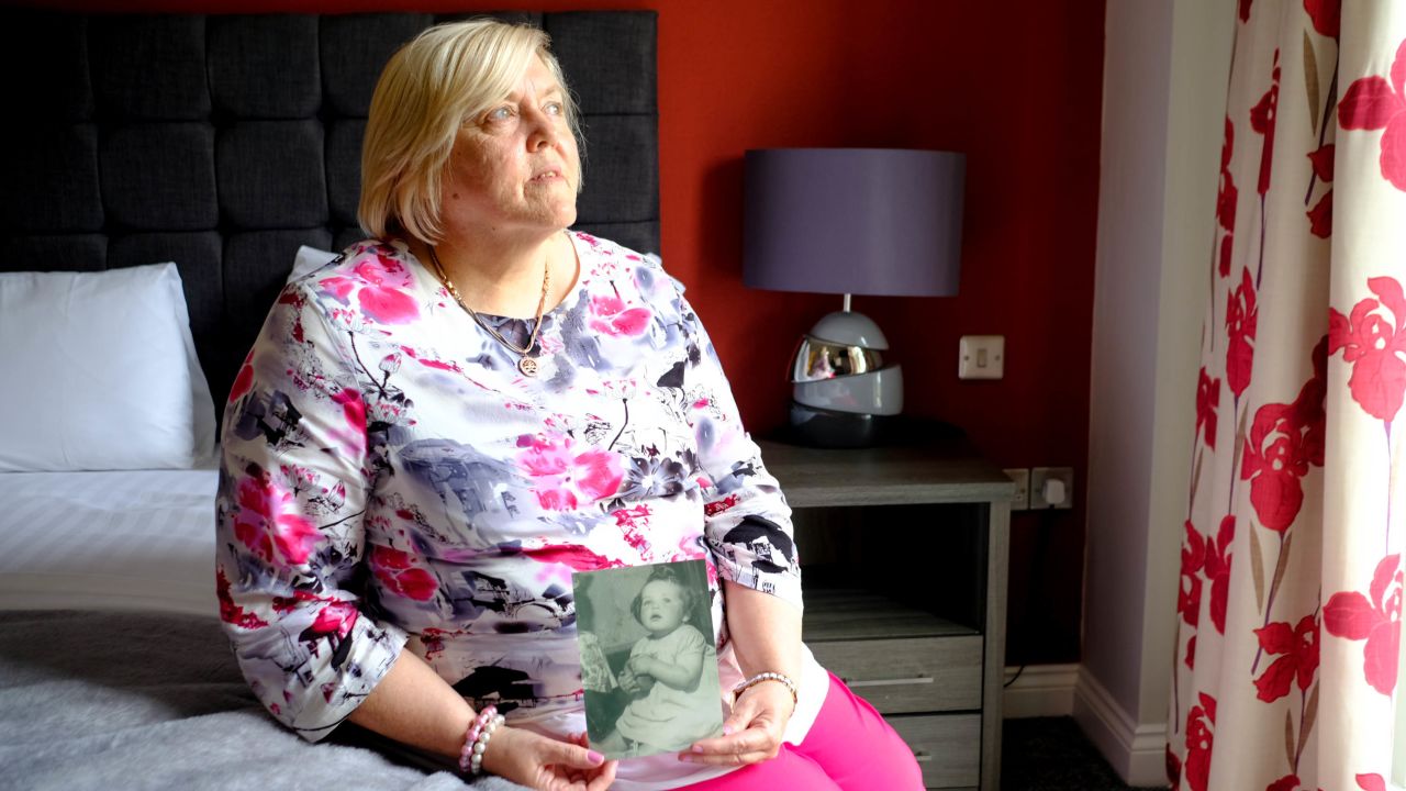 Survivor Teresa O'Sullivan holds a photo of herself as a baby, a photograph that was taken of children who were to be adopted from Tuam home. 