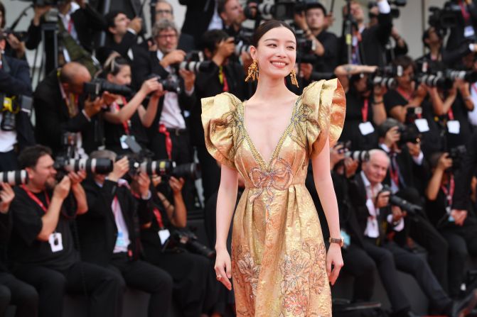 Chinese actress Ni Ni also opts for gold, a popular color at this year's Venice Film Festival.