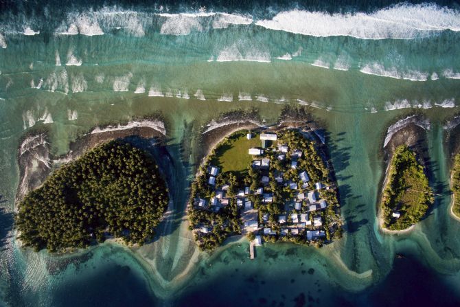 This aerial photo shows Ejit, an islet in the Marshall Islands, in 2015. The islands are threatened by rising seas. "I flew a drone above the island showing just how precarious its location is: Homes clinging to the edge of an eroding coastline as unrelenting waves chisel away at what remains," said <a href="index.php?page=&url=http%3A%2F%2Fwww.joshhaner.com%2F" target="_blank" target="_blank">Josh Haner,</a> a photographer with The New York Times. "After I saw what was happening on Ejit, I realized that climate change is not something nebulous that will only start affecting us in the future, but rather something happening right now. Residents are being forced to make the most difficult decision: Do they stay and build sea walls to buy some more time, or do they relocate?"