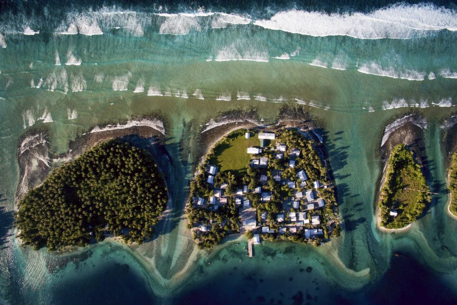 This aerial photo shows Ejit, an islet in the Marshall Islands, in 2015. The islands are threatened by rising seas. "I flew a drone above the island showing just how precarious its location is: Homes clinging to the edge of an eroding coastline as unrelenting waves chisel away at what remains," said <a href="http://www.joshhaner.com/" target="_blank" target="_blank">Josh Haner,</a> a photographer with The New York Times. "After I saw what was happening on Ejit, I realized that climate change is not something nebulous that will only start affecting us in the future, but rather something happening right now. Residents are being forced to make the most difficult decision: Do they stay and build sea walls to buy some more time, or do they relocate?"