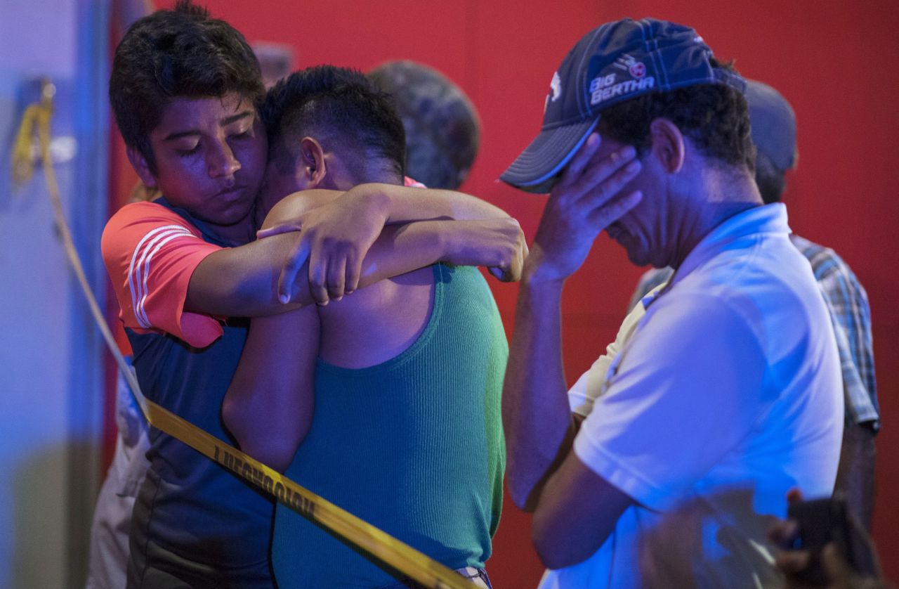 Two men console each other outside the <a href="https://www.cnn.com/2019/08/28/americas/mexico-bar-fire-intl/index.html" target="_blank">White Horse bar</a> in Veracruz, Mexico, where 23 people died in a fire caused by an arson attack.