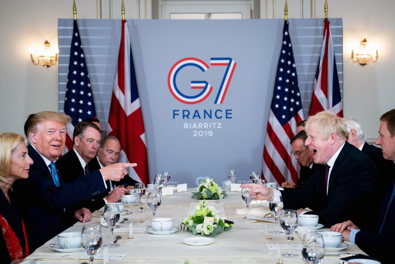 US President Donald Trump shares a laugh with UK Prime Minister Boris Johnson during a working breakfast at the G7 Summit in Biarritz, France, on Sunday, August 25.