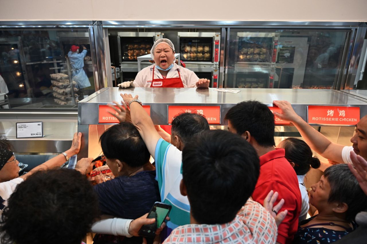 People reach out for roast chicken at the first-ever <a href="https://www.cnn.com/2019/08/27/business/costco-shanghai-china-store/index.html" target="_blank">Costco</a> outlet in China on August 27. The popular United States chain store was so popular in Shanghai on its opening day it was forced to close early because of overcrowding.