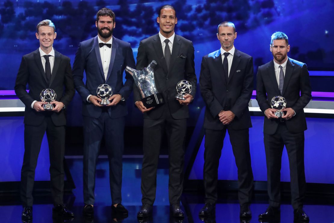Frenkie de Jong, Alisson Becker, Virgil van Dijk, UEFA President Aleksander Ceferin and Lionel Messi pose with their trophies.