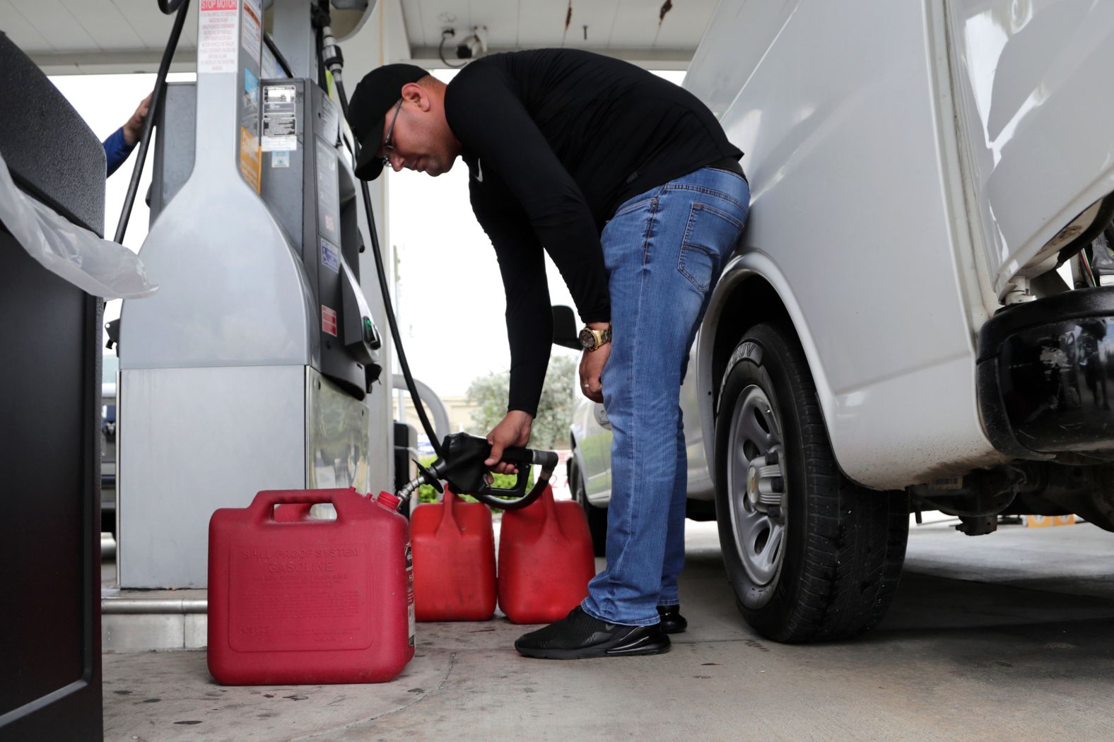 A man fills containers with gasoline in Hialeah, Florida, on August 29.