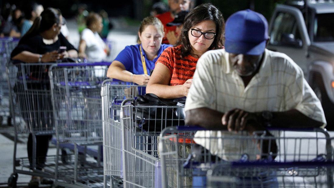 Shoppers wait in line before sunrise for a Sam's Club store to open in Kissimmee, Florida.
