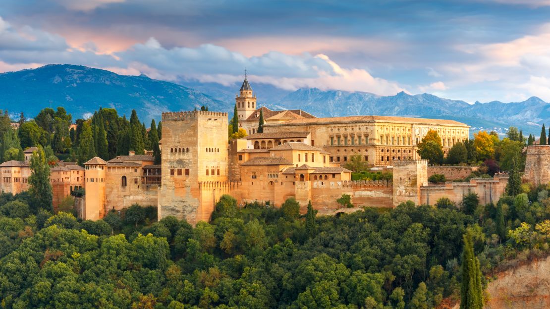 The Alhambra Palace and fortress complex glows during sunset in Granada.