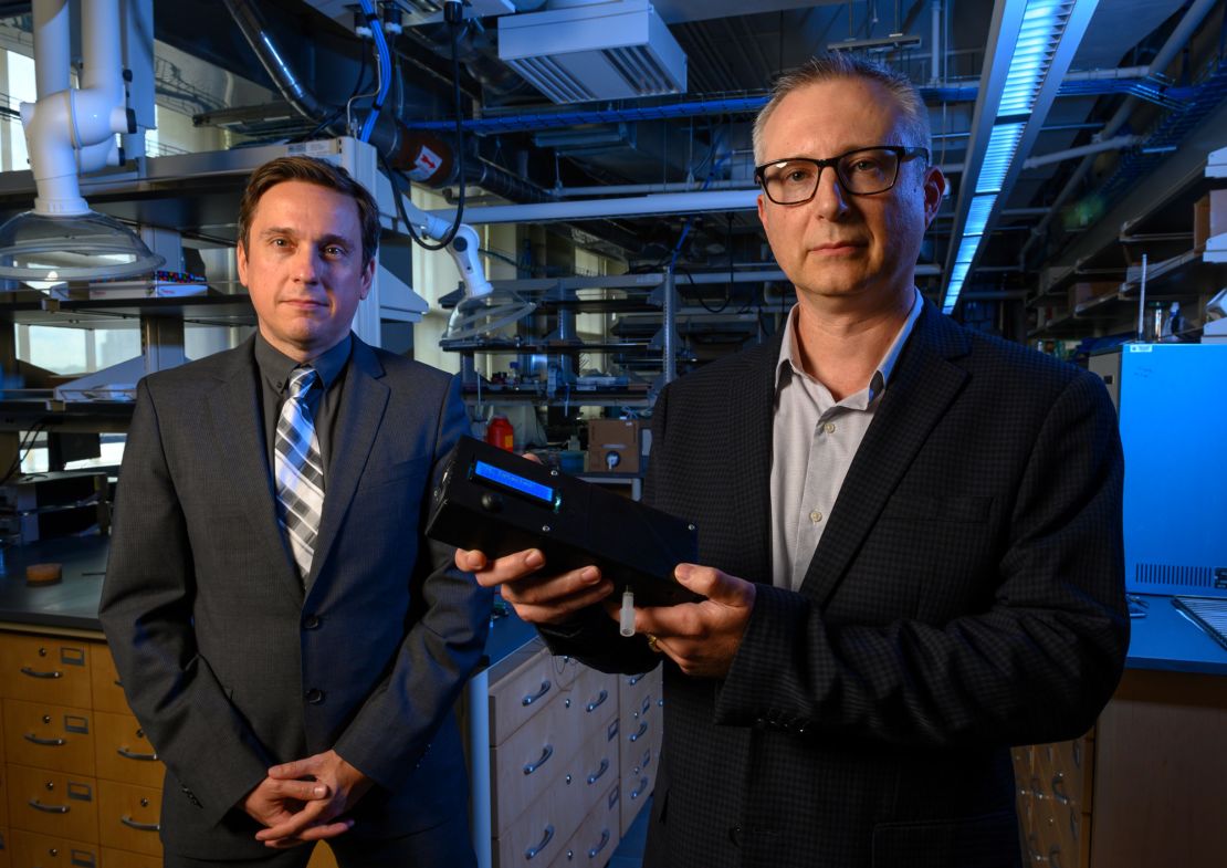 Ervin Sejdic (left) and Alexander Star (right) hold the THC breathalyzer prototype they developed at the University of Pittsburgh.