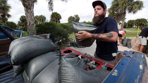Matt Rohrer loads sandbags in the back of his vehicle in Flagler Beach, Florida, on Friday, August 30.
