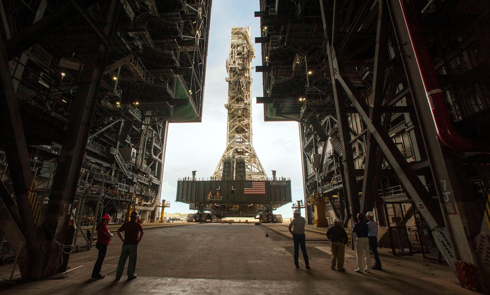 NASA employees watch as the Artemis launch tower is rolled back inside a building at the Kennedy Space Center in Cape Canaveral, Florida.