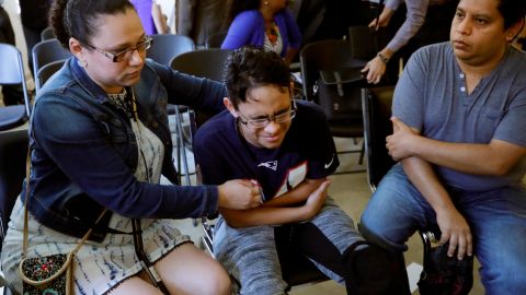 Gary Sanchez, of Honduras, right, watches as his wife, Mariela, comforts their son, Jonathan, 16, during a news conference, Monday, Aug. 26, 2019, in Boston. The Sanchez family came to the United States seeking treatment for Jonathan's cystic fibrosis.