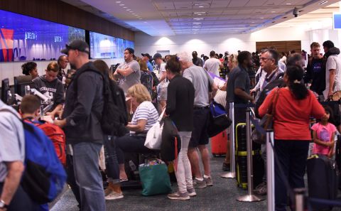 Passengers arrive at Orlando International Airport on Saturday, August 31.