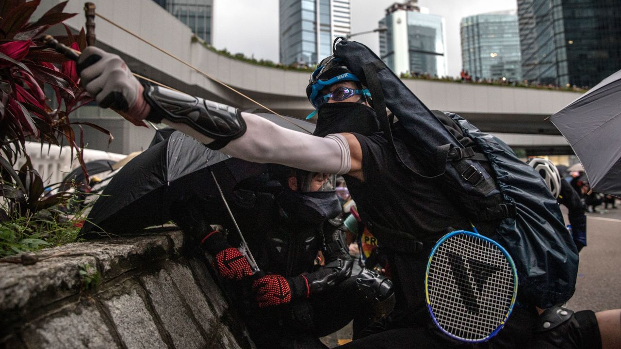 A protester uses a slingshot outside the Central Government Complex during clashes with police on Saturday, August 31. Thousands of pro-democracy protesters held an anti-government rally one day after several leading activists and lawmakers were arrested in a sweeping crackdown.