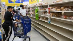 People shop for supplies before the arrival of Hurricane Dorian, in Freeport, Bahamas, Friday, Aug. 30, 2019. Forecasters say the hurricane is expected to keep on strengthening and become a Category 3 later in the day. (AP Photo/Tim Aylen)