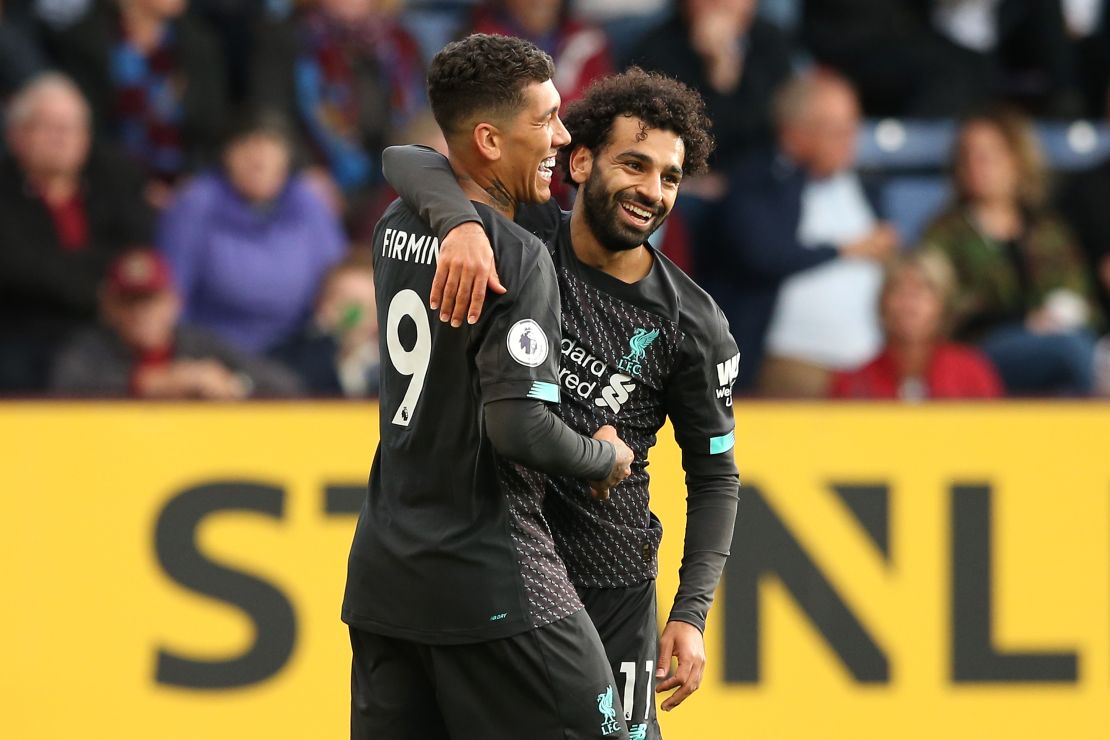 Roberto Firmino celebrates his goal with teammate Mohamed Salah.