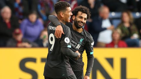Roberto Firmino celebrates his goal with teammate Mohamed Salah.