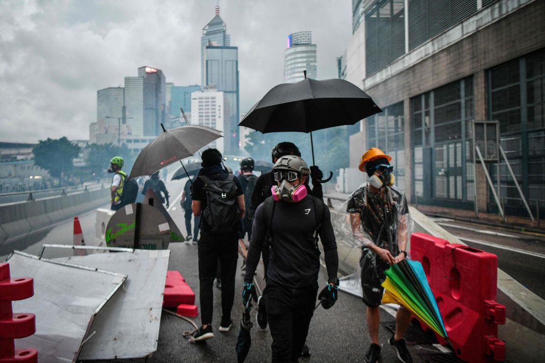 Protesters gather on a road as police fire tear gas outside the government headquarters in Hong Kong on August 31, 2019.