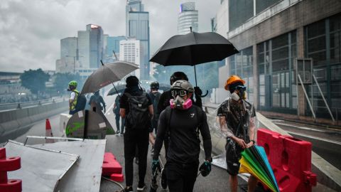 Protesters gather on a road as police fire tear gas outside the government headquarters in Hong Kong on August 31, 2019.