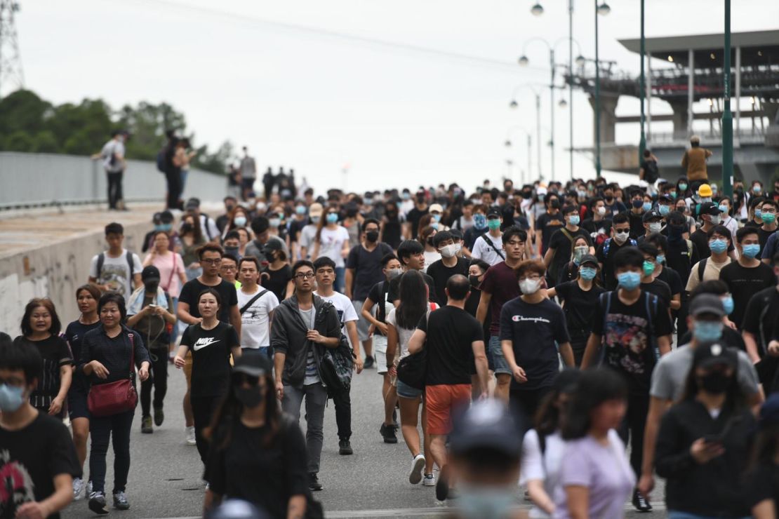 Crowds of protesters head from Hong Kong international airport to nearby Tung Chung.