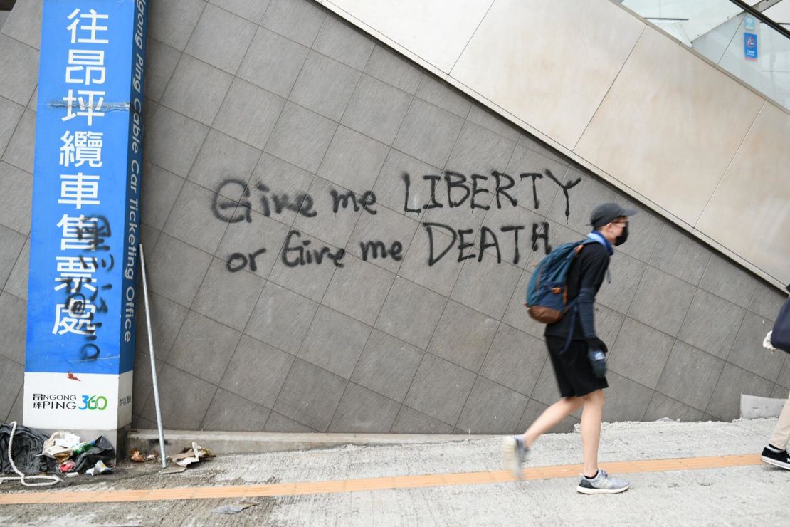 Graffiti on a wall in Tung Chung, where protesters fled after disrupting transport to and from Hong Kong airport.