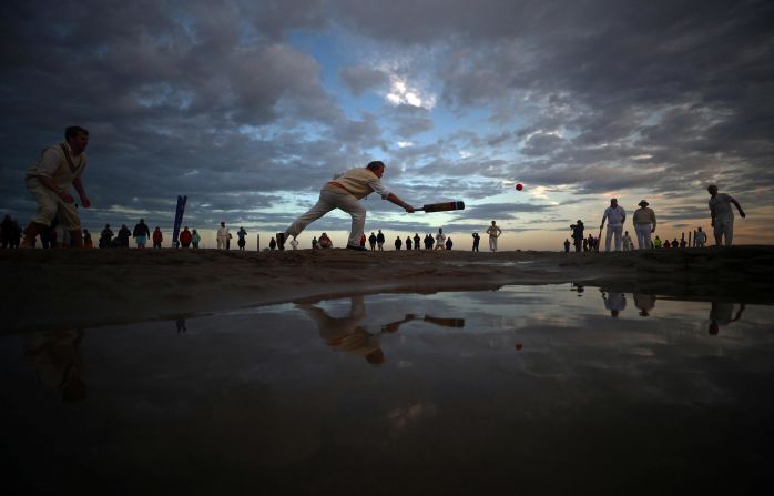 Players participate in the annual Brambles Sandbank cricket match during low tide in the Solent, strait of the English Channel, on September 1.
