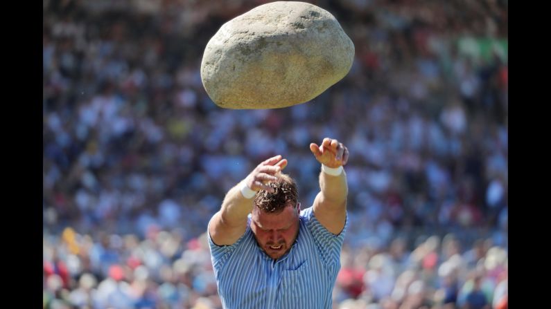 Martin Jakober throws the 83.5kg Unspunnen stone during the ESAF-Federal Alpine Wrestling Festival in Zug, Switzerland, on Sunday, August 25.