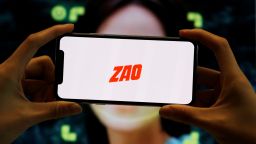 The logo of the Chinese app ZAO, which allows users to swap their faces with celebrities and anyone else, is seen on a mobile phone screen in front of an advertisement of the app, in this illustration picture taken September 2, 2019. REUTERS/Florence Lo/Illustration