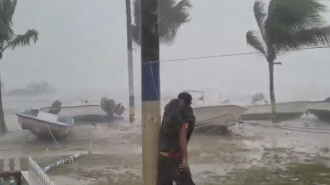Earlyn Mills grapples with the storm on Harbour Island, Bahamas. 