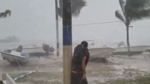 A man is caught out in the elements as Hurricane Dorian lashes the Bahamas.