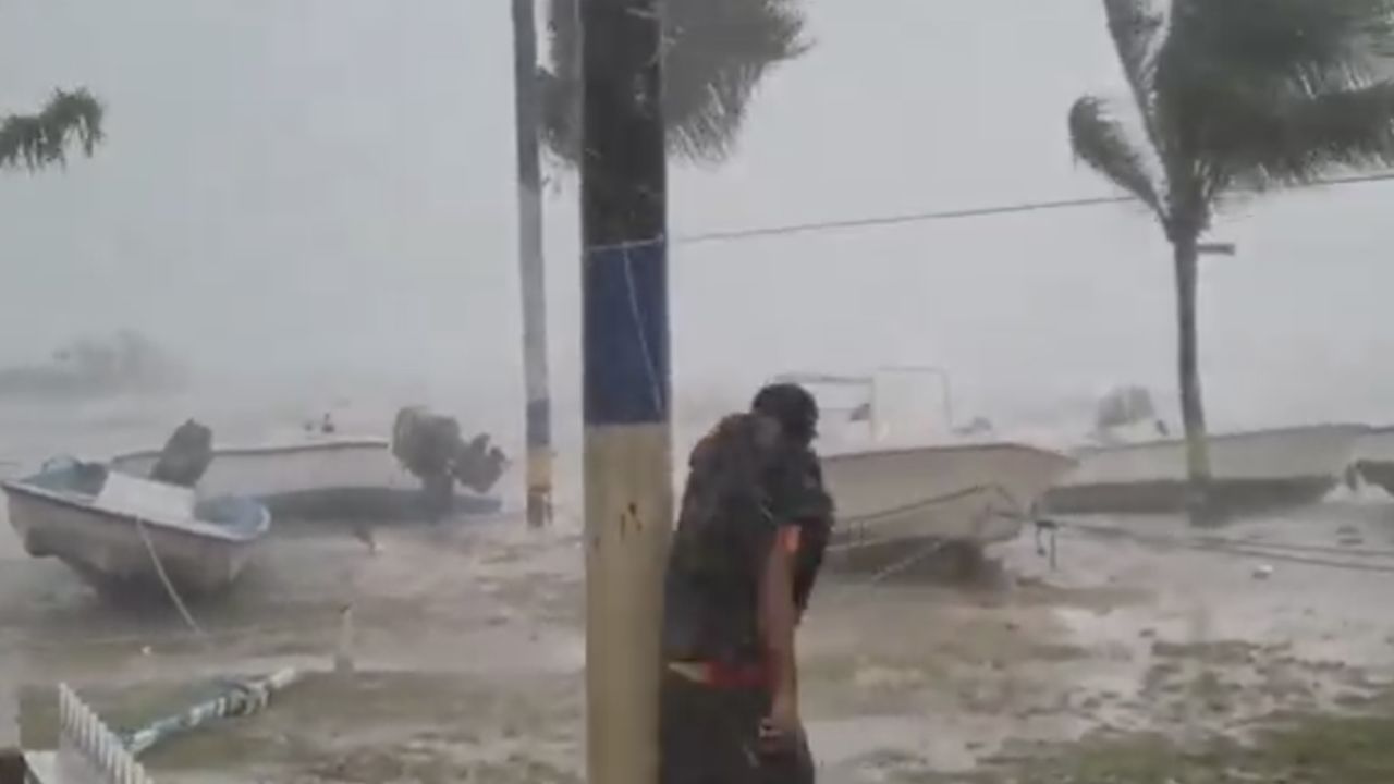 Earlyn Mills grapples with the storm on Harbour Island, Bahamas. 
