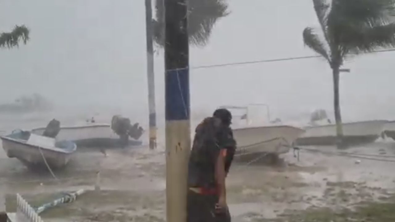 Earlyn Mills grapples with the storm on Harbour Island, Bahamas.