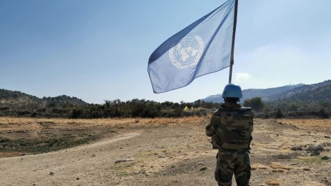 Outside the disputed Shebaa Farms, an Indian UN peacekeeper raises the UN flag to mark the demarcation line between Israel and Lebanon.