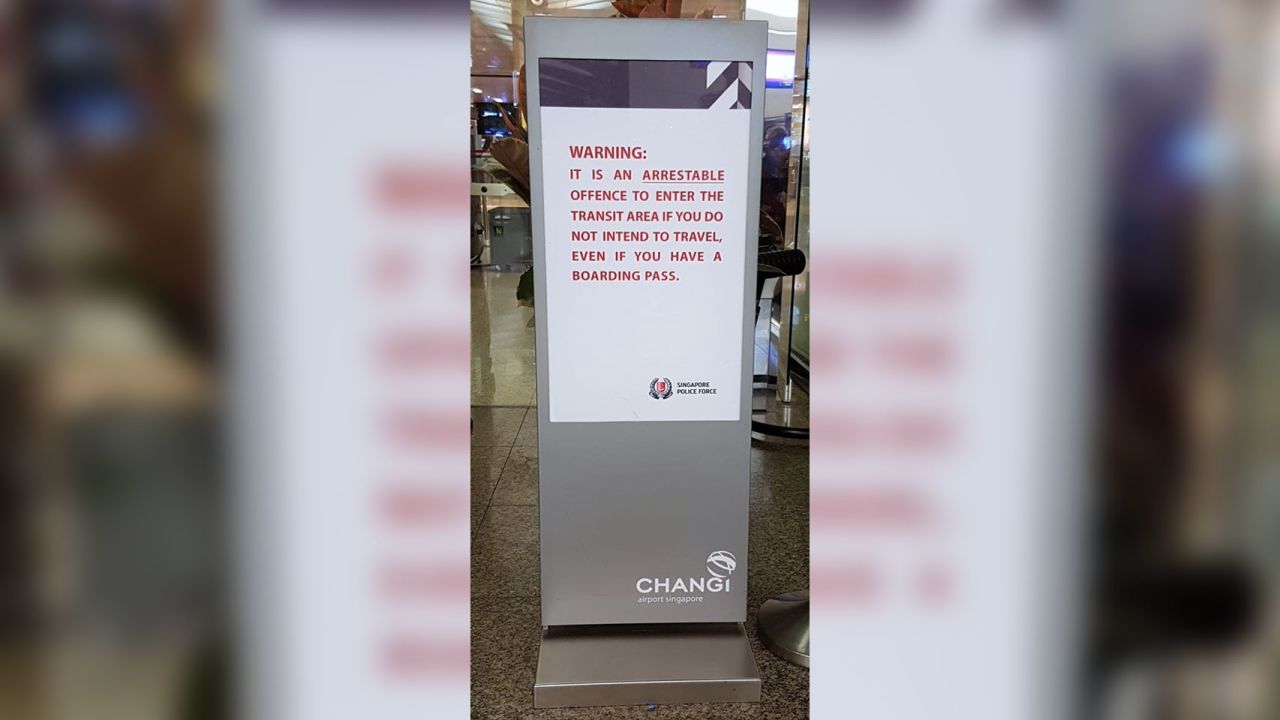 A police sign in Singapore Changi airport warns passengers against entering the transit area illegally.