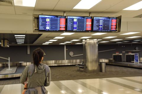 A passenger looks at the flight board at the Fort Lauderdale-Hollywood International Airport on September 2. The airport canceled flights and closed because of winds caused by Dorian.