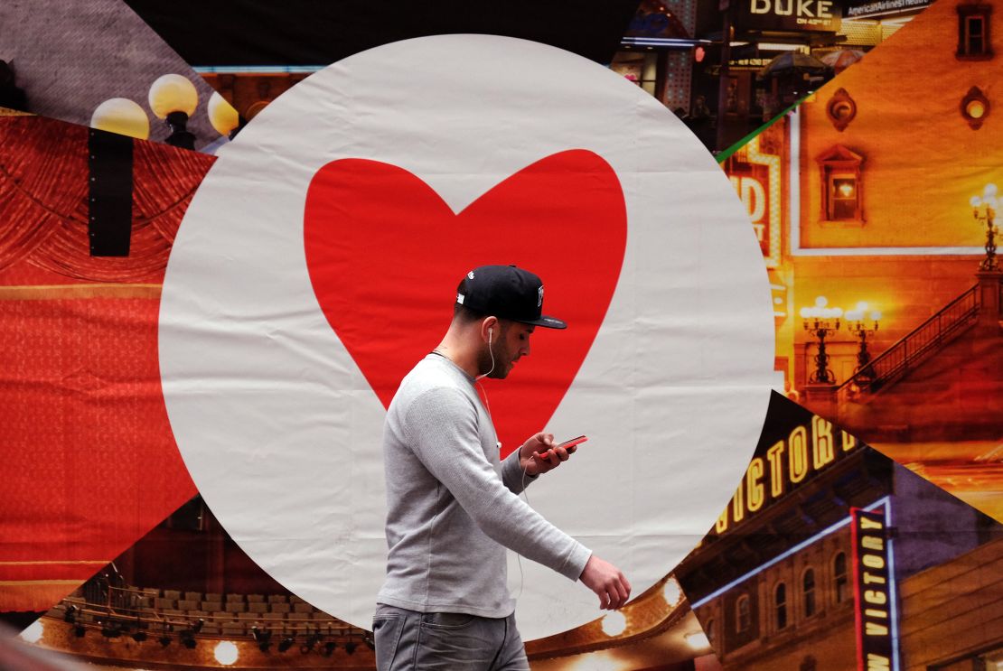 A man uses his smart phone as he walks along a street in New York on March 4, 2015. Some linguists have warned that the lack of support for minority languages on many platforms could hasten their demise.