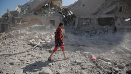 A Yemeni man walks amid the rubble of a Houthi detention center destroyed by Saudi-led airstrikes, that killed at least 60 people and wounding several dozen according to officials and the rebels' health ministry, in Dhamar province, southwestern Yemen, Sunday, Sept. 1, 2019. The officials said the airstrikes took place Sunday and targeted a college in the city of Dhamar, which the Houthi rebels use as a detention center. The Saudi-led coalition said it had hit a Houthi military facility used as storages for drones and missiles in Dhamar. (AP Photo/Hani Mohammed)