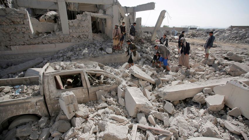 People inspect the rubble at a Houthi detention center destroyed by Saudi-led airstrikes, that killed at least 60 people and wounding several dozen according to officials and the rebels' health ministry, in Dhamar province, southwestern Yemen, Sunday, Sept. 1, 2019. The officials said the airstrikes took place Sunday and targeted a college in the city of Dhamar, which the Houthi rebels use as a detention center. The Saudi-led coalition said it had hit a Houthi military facility used as storages for drones and missiles in Dhamar. (AP Photo/Hani Mohammed)