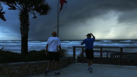 Two men observe an approaching squall caused by Hurricane Dorian on September 3 in Ormond Beach, Florida.
