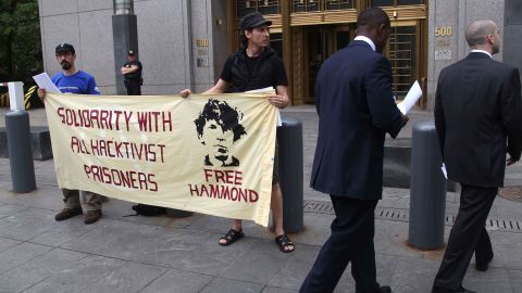 Protesters stand in front of the federal courthouse during the arraignment of Jeremy Hammond in New York, Monday, May 14, 2012.