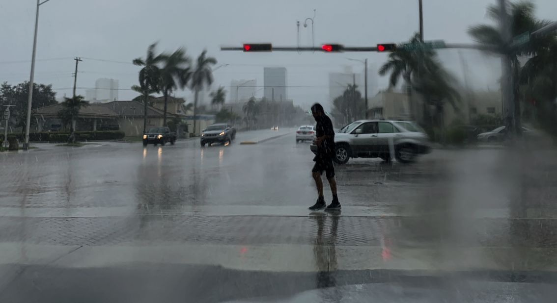 A man crosses a street during a downpour in Fort Lauderdale, Florida, on September 2.