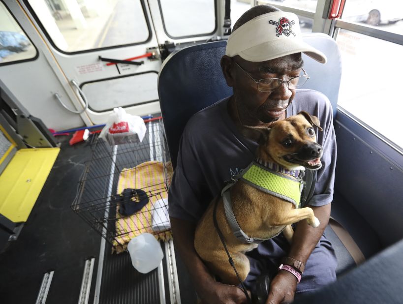 Eddie Wright and his dog, Vino, wait on a bus to evacuate Brunswick, Georgia.
